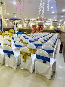 a row of chairs lined up in a room at Nilansh homes and hotels in Lucknow