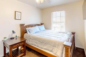 a bedroom with a bed and a table and a window at Casa Killeen in Killeen
