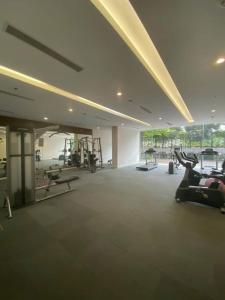 a gym with tread machines and people exercising in it at Park 12 Homestay in Hanoi