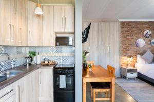 a kitchen with a sink and a table in a room at River View in Potchefstroom