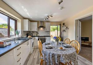 a kitchen with a table with a table cloth on it at Yr Annexe Mermur y Nant in Aberystwyth