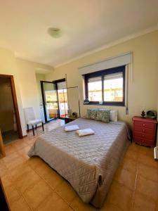 ein Schlafzimmer mit einem großen Bett mit zwei Handtüchern darauf in der Unterkunft houses&halfhouses historic street in Caminha