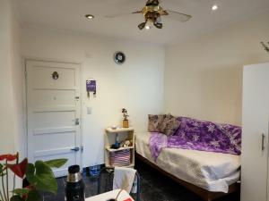 a bedroom with a bed and a ceiling fan at Departamento en la "costa-Santa Teresita" 905 in Santa Teresita