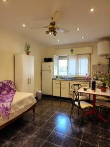 a kitchen with a bed and a table with chairs at Departamento en la "costa-Santa Teresita" 905 in Santa Teresita