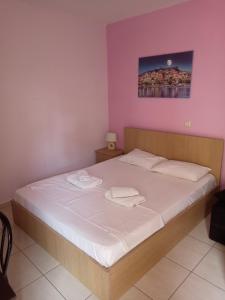 a bedroom with a bed with two towels on it at Ismini Cozy Rooms in Kavala