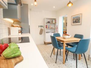 a kitchen and dining room with a table and chairs at Bay Cottage in Weymouth