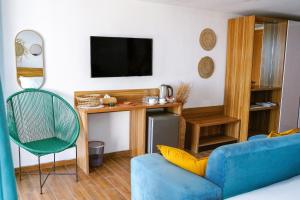 a living room with a blue couch and a television at Vogue Beach Resort in Lagos