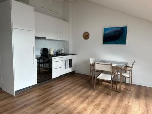 a kitchen and dining room with a table and chairs at Neue Einzimmer Dachwohnung in Seengen