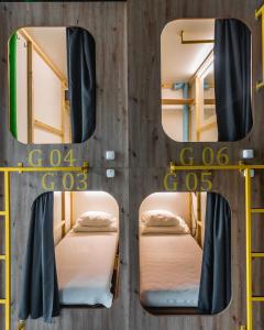 a group of bunk beds in a prison cell at Capsule Hostel Logistic Vilnius in Vilnius