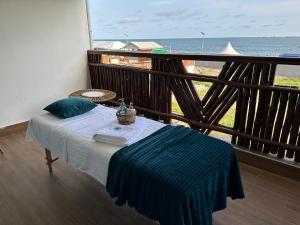 a bedroom with a bed with a view of the ocean at Vogue Beach Resort in Lagos