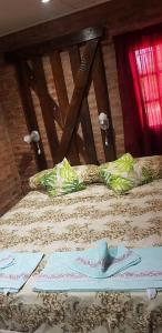a bed with two pillows on top of it at CABAÑAS HORNERO in San José del Rincón