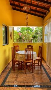 a dining room with a table and chairs at Casa Amarela Alter in Alter do Chao