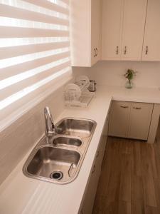 a kitchen with a sink and a counter top at Las Casitas en Miraflores Guayaquil in Guayaquil