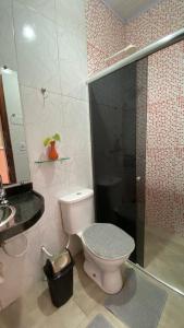 a bathroom with a toilet and a shower and a sink at Casa Amarela Alter in Alter do Chao +21 photos