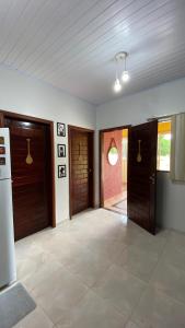 an empty room with two doors and a tile floor at Casa Amarela Alter in Alter do Chao