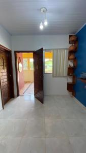 an empty room with a door and a tile floor at Casa Amarela Alter in Alter do Chao