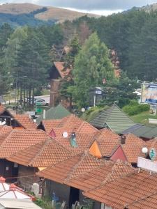 an overhead view of roofs of houses with trees at Golden Apartman in Zlatibor