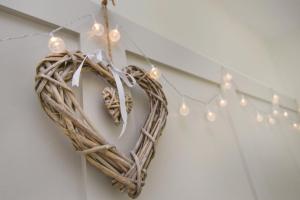 a heart wreath hanging on a wall with lights at A spacious home from home with spectacular views in Heywood