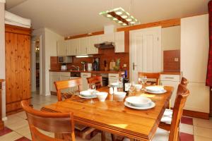 a kitchen and dining room with a wooden table and chairs at Villa Maria Wohnung 10 in Ostseebad Koserow