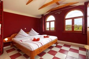 a bedroom with a bed with red walls and windows at Villa Maria Wohnung 10 in Ostseebad Koserow