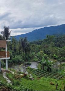 a view of a garden with mountains in the background at Villa Bumisoka in Purwakarta