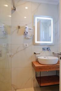 a bathroom with a sink and a glass shower at Vila Shpetimi in Ksamil