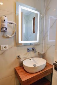 a bathroom with a white sink and a mirror at Vila Shpetimi in Ksamil