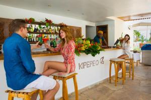 a man and a woman sitting at a bar at Fruit & Spice Wellness Resort Zanzibar in Kizimkazi +37 photos