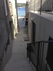 an alley with stairs and a view of the water at Villa Neka in Primošten