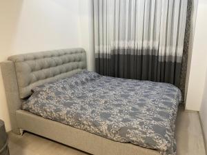 a bed in a bedroom next to a window at Pika Hostel in Prizren