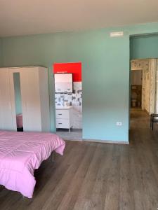 1 dormitorio con 1 cama con colcha rosa en VeniceMaskPadova, en Padua