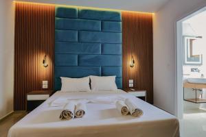 a bedroom with a large bed with towels on it at Vila Shpetimi in Ksamil