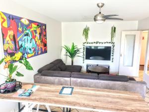 a living room with a couch and a table at La Casa Picasso in Villepinte