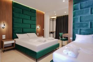 a hotel room with two beds and a desk at Vila Shpetimi in Ksamil