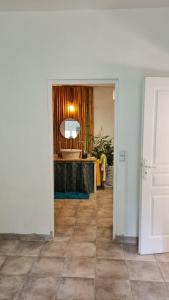 a hallway with a room with a table and a mirror at gîte du bambou bleu 