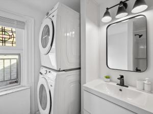 a white bathroom with a washing machine and a sink at Shadyside, Pittsburgh, Modern and Stylish 1 Bedroom Unit5 with Free Parking in Pittsburgh
