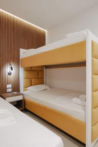 a bedroom with two bunk beds next to each other at Vila Shpetimi in Ksamil