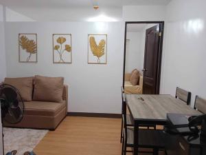 a living room with a couch and a table at My Bubble Affordable Staycation in Marilao