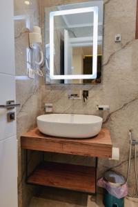 a bathroom with a sink and a mirror at Vila Shpetimi in Ksamil