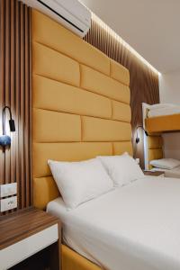 a bedroom with a large bed and a wooden headboard at Vila Shpetimi in Ksamil