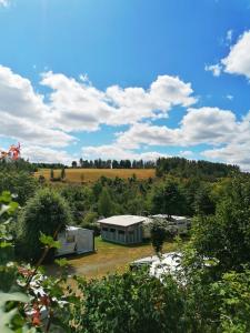 a view of a farm with tents and trees at Campingplatz Am Bärenbache in Braunlage