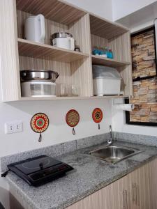 a kitchen with a sink and a counter top at My Bubble Affordable Staycation in Marilao