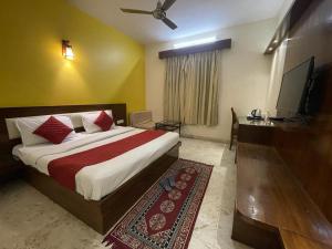 a bedroom with a bed and a flat screen tv at Abhi Residency Hotel in New Delhi