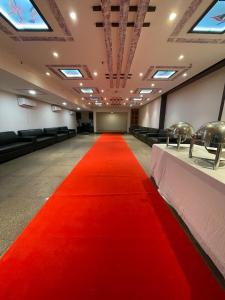 a red carpet in a conference room with a red carpet at Abhi Residency Hotel in New Delhi