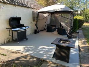 a backyard with a grill and a gazebo at A Spicy Swedish Cottage in Salt Lake City