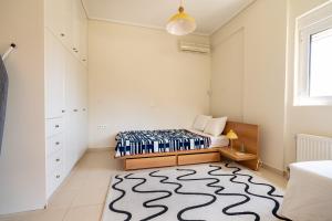 a bedroom with a bed and a rug at Koropi 3 bedroom Luxurious Apartment 5 pers- Angel House in Koropi