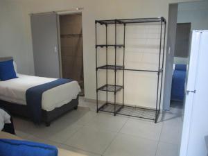 a bedroom with a bed and a book shelf at LEKKER RUS in Bloemfontein
