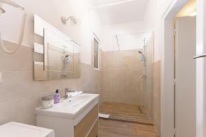 a white bathroom with a sink and a shower at Rozelor Accommodation in Timişoara