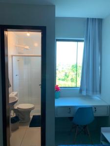 a bathroom with a sink and a toilet and a window at Aconchego do francês - Praia do Francês - Alagoas/Maceio in Marechal Deodoro