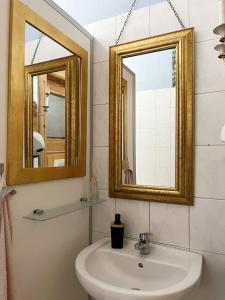 a bathroom with a sink and a mirror at Homeplanet Hostel in Leipzig